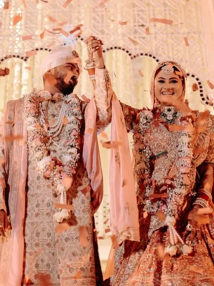 That moment of pure joy after the varmala exchange. We ensure the celebration continues with elements like a confetti shower to capture the happiness.