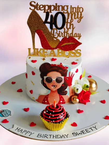 Stepping into 40 like a boss. This cake was designed for a milestone birthday, featuring a fun, fashionable character, a glittery high-heel topper, and a matching cupcake.