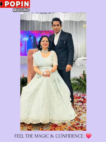 A beautiful couple posing at their event. He is wearing a classic black suit from my collection, which perfectly complements her elegant white and silver gown.
