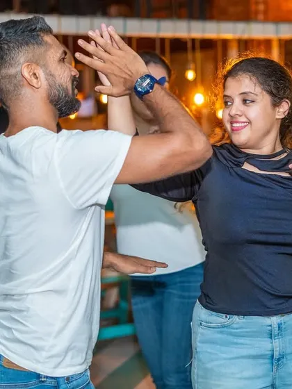 A high-five mid-dance! It’s all about fun, encouragement, and celebrating each other's moves.