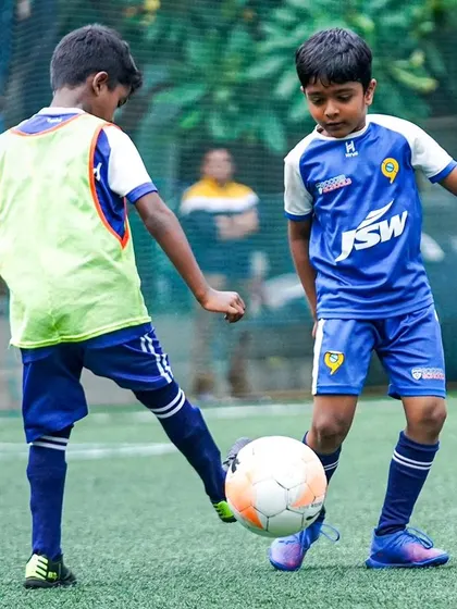 Two players compete for the ball in a trial match. These games are the best way for us to assess a player's overall ability.