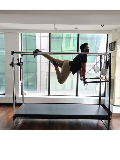 This suspended pose on the Cadillac builds upper body and core strength while challenging your stability.