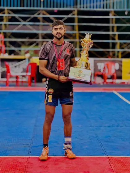 Vicky Bainsla, one of our promising players, holding the trophy after a successful tournament. He was selected for the 50th Junior National Championship.