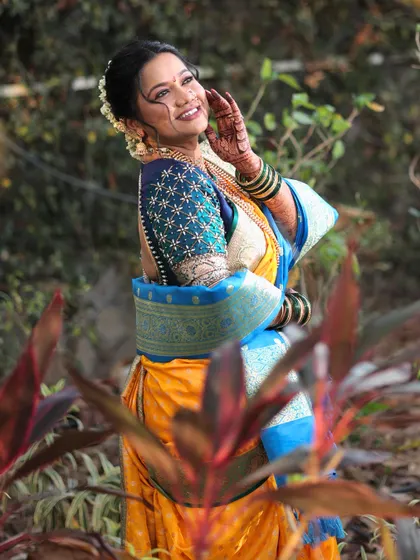 A joyful, candid shot of the bride. Her makeup is kept fresh and radiant, ensuring her happiness shines through as the main highlight of her look.