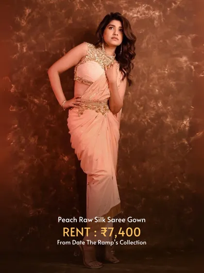 A peach raw silk saree gown that drapes beautifully and offers a sophisticated, modern silhouette.