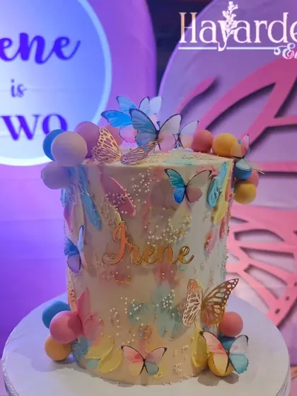 A stunning butterfly-themed cake, perfectly matching the party's decor. I can coordinate with your baker to ensure a cohesive look.