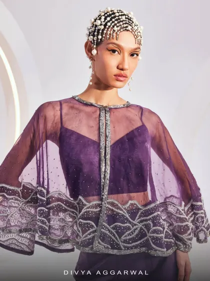 A detailed shot of the ZOEY Cape Set, focusing on the craftsmanship of the embellished organza cape.