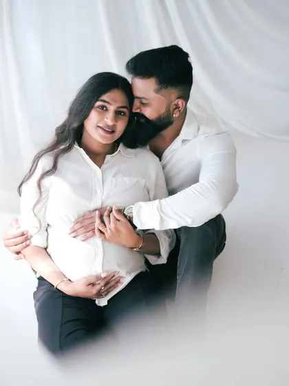 A classic and intimate couple's portrait. The simple white shirts and high-contrast lighting create a timeless feel, focusing purely on the couple's connection.