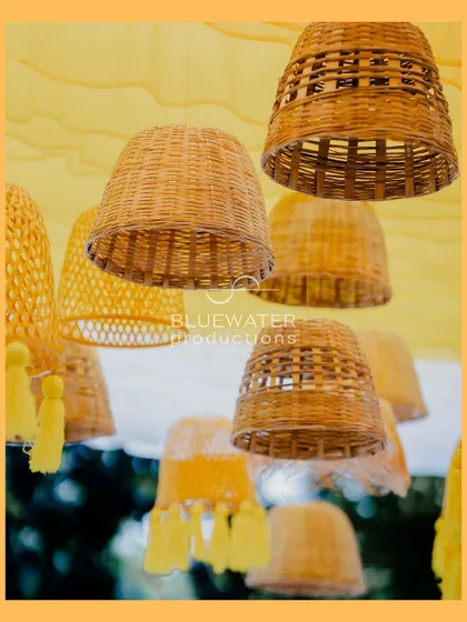A close-up of the woven lampshades used in the Haldi decor, a simple element that adds significant texture and warmth.