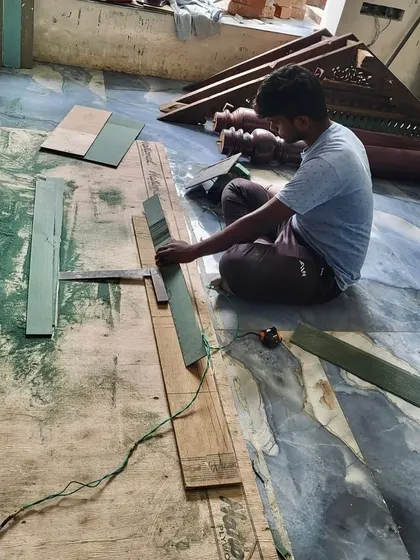 A craftsman at work, preparing wooden elements for an interior. Our hands-on approach extends to every detail, including the selection and finishing of materials that will bring warmth and character to the space.