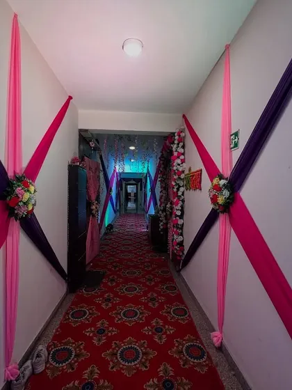 The same hallway decorated with pink and purple drapes, showing how the look can be changed to match different color themes.