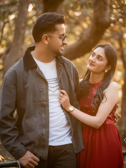 A loving gaze shared between the couple, with her hand gently on his jacket. This is a simple, beautiful portrait of their connection.