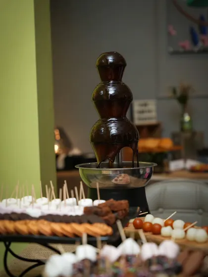 Yummy yum! The dessert table is set and ready for guests, with the chocolate fountain flowing and an assortment of delicious dippables.