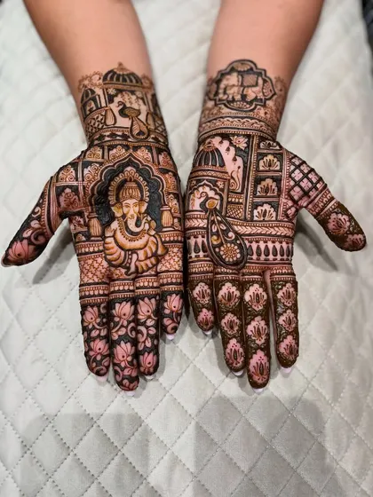 The beauty is in the details. This design features a finely detailed portrait of Lord Ganesha for blessings, surrounded by delicate lotus motifs and traditional Indian patterns.