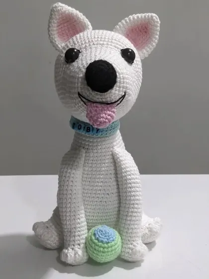 A custom crochet portrait of a beloved pet dog named Toby. I captured his happy expression, floppy tongue, and even included his favorite little ball to make this handmade plushie extra special.