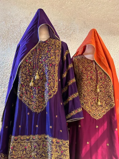 A showcase of heavily embroidered suits for Karwachauth or Diwali. The rich jewel tones of purple and magenta are paired with intricate gold zardozi work for a truly royal look.