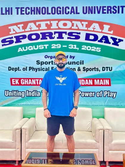 Standing in front of the National Sports Day banner at DTU. The message "Uniting India Through The Power of Play" is something I strongly believe in and promote through my work.