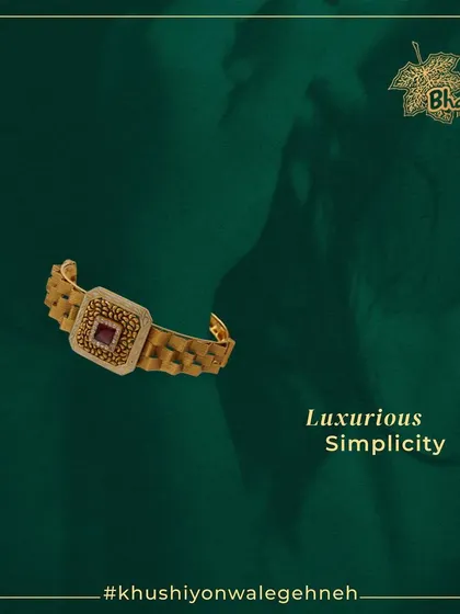 Adorn your wrist with the ultimate statement piece. This breathtakingly beautiful bracelet features a square centerpiece with exquisite Kundan and a central ruby, set on a modern, textured gold band.
