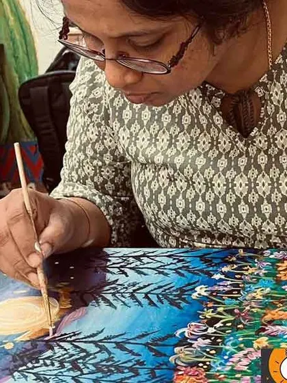 A close-up of an artist's hands, carefully adding details to a whimsical landscape. This image captures the focus and precision I teach in my classes.