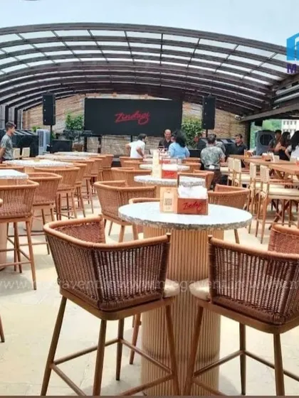 A bustling rooftop bar fully equipped with our high-top bar chairs and tables. The retractable roof overhead makes it a perfect all-weather destination for patrons.