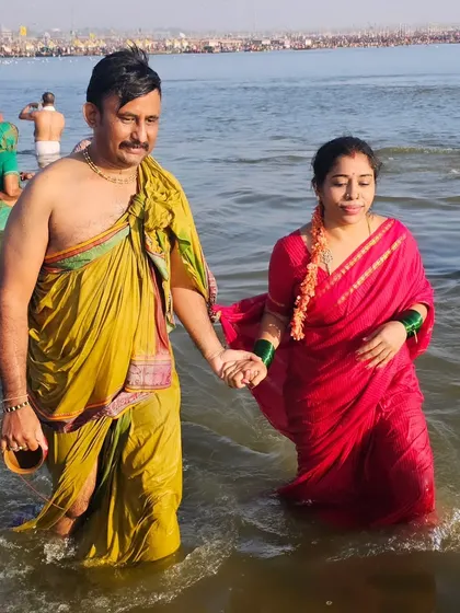A cherished moment with my husband, taking a holy dip together at the Triveni Sangam during the Kumbh Mela.