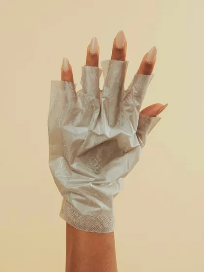 This is my vegan collagen hand treatment in action. The gloves are pre-filled with a rich serum containing plant-derived collagen and olive oil to deeply moisturize your hands while I work on your nails.
