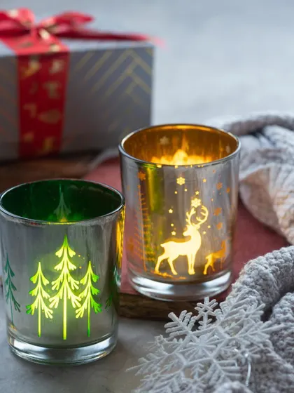 Another look at my Christmas-themed mercury glass candle holders. The reindeer and tree designs are so festive.