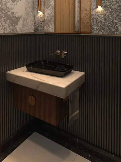 This powder room features sleek black fixtures, black wall paneling, and a floating marble countertop with a unique black sink basin.