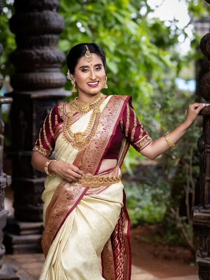 The classic off-white and maroon wedding saree paired with my traditional gold-plated temple jewellery. A timeless choice for any bride.
