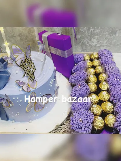 A luxurious birthday or anniversary hamper featuring a stunning lavender butterfly cake and a beautiful arrangement of Ferrero Rocher chocolates.