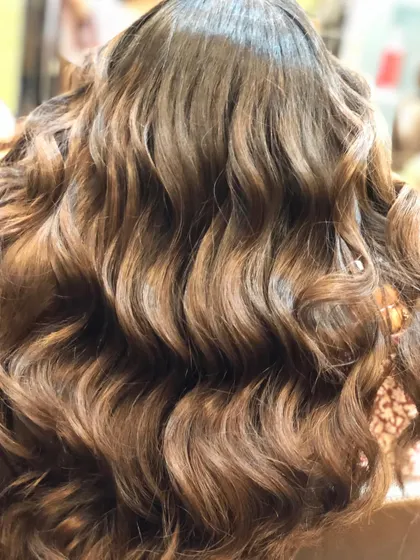 The full view of the warm brown balayage, demonstrating how the colour adds body and dimension to the hair.