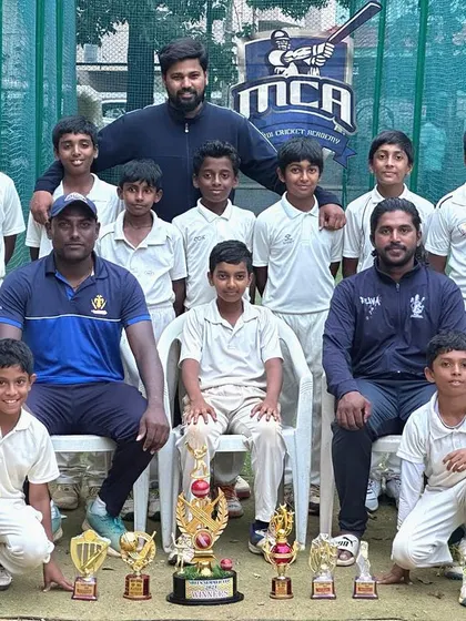 Our victorious team posing with the coaches and the Sheen Cup trophy after winning the tournament for the second time in a row.