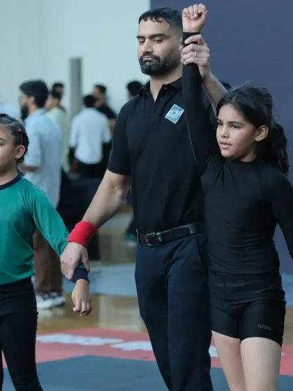 Being a certified referee for organizations like AJP gives me a deep understanding of the sport from all angles. Here I am officiating a youth grappling match. This experience helps me train my students with a complete perspective.