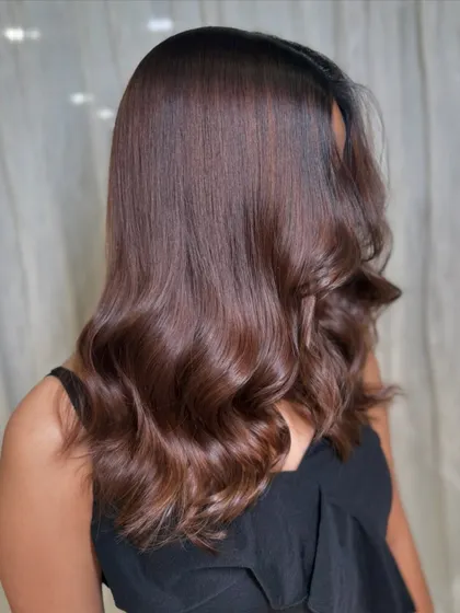 A still shot capturing the beautiful waves and rich brown color. This is a perfect example of a classic, glamorous hairstyle.