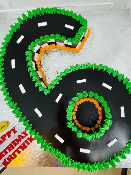 A 4kg cake expertly carved into the shape of the number '6' and designed to look like a winding road.
