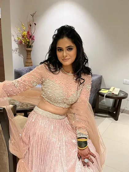 Pretty princess Pradnya in her full sangeet attire. The light pink lehenga is beautifully detailed, and her makeup is soft and glamorous.