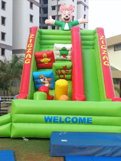 The Zig Zag Slide is a unique inflatable climber that challenges kids to navigate soft, cushioned obstacles to reach the top. It's a great alternative to a standard slide for active children.