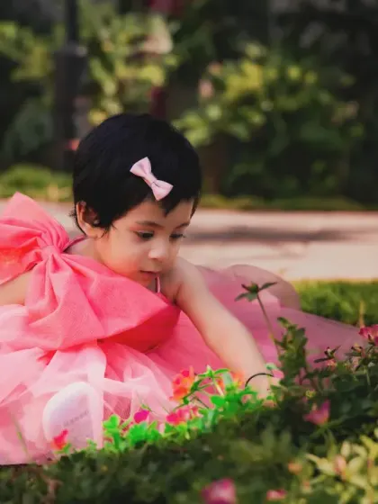 A moment of quiet curiosity, exploring the flowers in the garden. Outdoor shoots are great for capturing a child's sense of wonder.