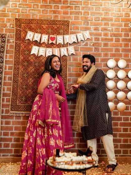 "Our Story Begins." A candid moment from an engagement party, where the couple's joy is palpable as they celebrate with loved ones.