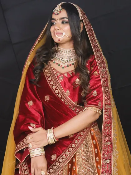 The rich maroon velvet and detailed embroidery on this bridal lehenga create a truly royal look. It's a perfect rental for a winter wedding.