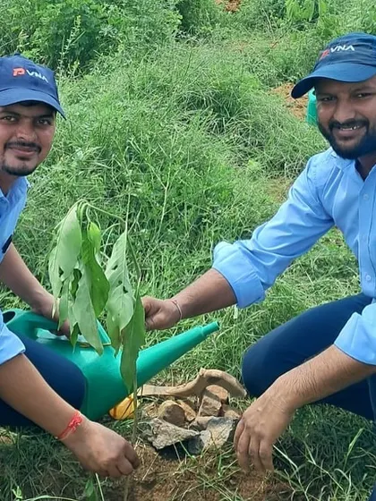 Two employees from Padmini VNA Mechatronics Limited water a newly planted sapling at Aravali Nagar Van, helping to boost the forest's biodiversity.