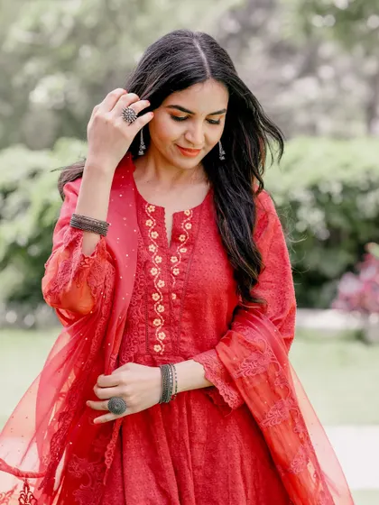 A thoughtful, candid portrait during a pre-wedding shoot. The natural outdoor light and relaxed pose make for an authentic and beautiful image.