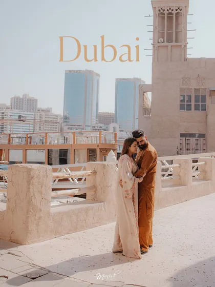 A pre-wedding shoot in Old Dubai, where the couple's traditional attire beautifully complements the rustic architecture.