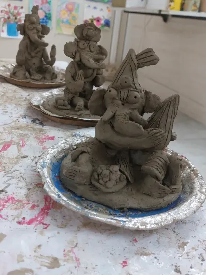 A close-up of the unique, handcrafted Ganesha idols made by the children. Each one has its own personality, reflecting the individual creativity of its little maker during our clay workshop.