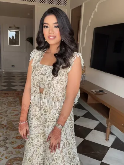 A full-length shot of this gorgeous ivory outfit. The makeup is kept soft and glowing to maintain a cohesive and elegant look.