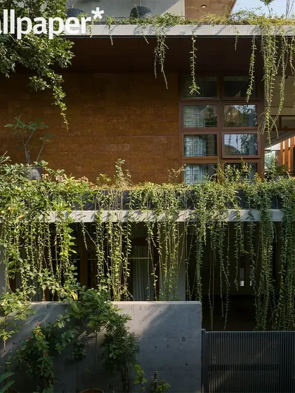 The facade detail with its curtain of green creepers, as featured in Wallpaper*.
