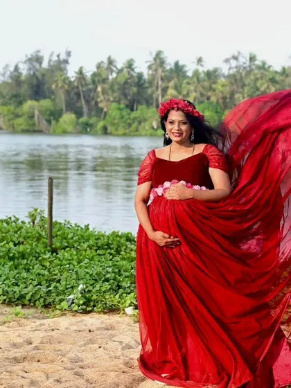 A client looking radiant in our red flying gown during her beachside maternity shoot in the Mangalore region.