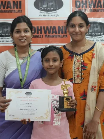 A student with her mother and teacher, celebrating her success.