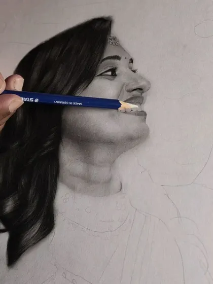 A detail shot showing the use of a pencil to define the teeth and create a realistic smile.