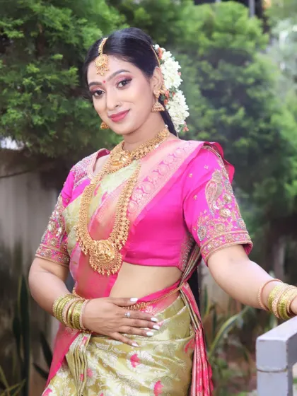 Another beautiful shot of the South Indian bride, showcasing the complete look in a natural setting.